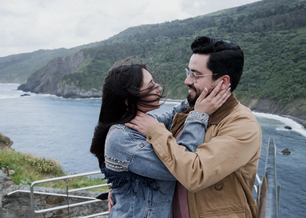 Pedida de mano en San Juan de Gaztelugatxe | Fotógrafo en Bilbao 7 La emoción de una pedida de mano en San Juan de Gaztelugatxe
Fotografiar una pedida de mano es muy diferente a fotografiar una sesión de pareja.
Hay algo que cambia completamente.
La sorpresa.
Como fotógrafo, tienes que estar pendiente de muchas cosas al mismo tiempo: la luz, el entorno, las personas que pasan, la posición de la pareja y, sobre todo, ese pequeño instante en el que todo cambia.
Pero también hay que saber desaparecer.
No dirigir demasiado.
No convertir un momento íntimo en una sesión de fotos.
Simplemente observar.
Esperar.
Y estar preparado.
En una pedida de mano, muchas veces la fotografía más importante no es la que muestra el anillo.
Es la que muestra la reacción.
La mirada.
La sorpresa.
La sonrisa que aparece sin pensar.
Ese segundo en el que una persona entiende lo que está pasando y el resto del mundo parece desaparecer.
